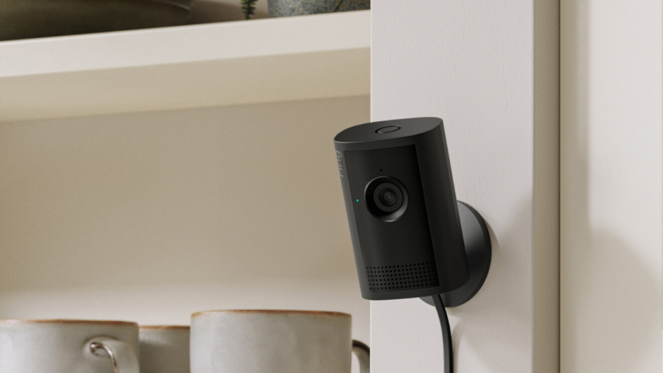 Ring Indoor Camera on a wall next to a kitchen shelf