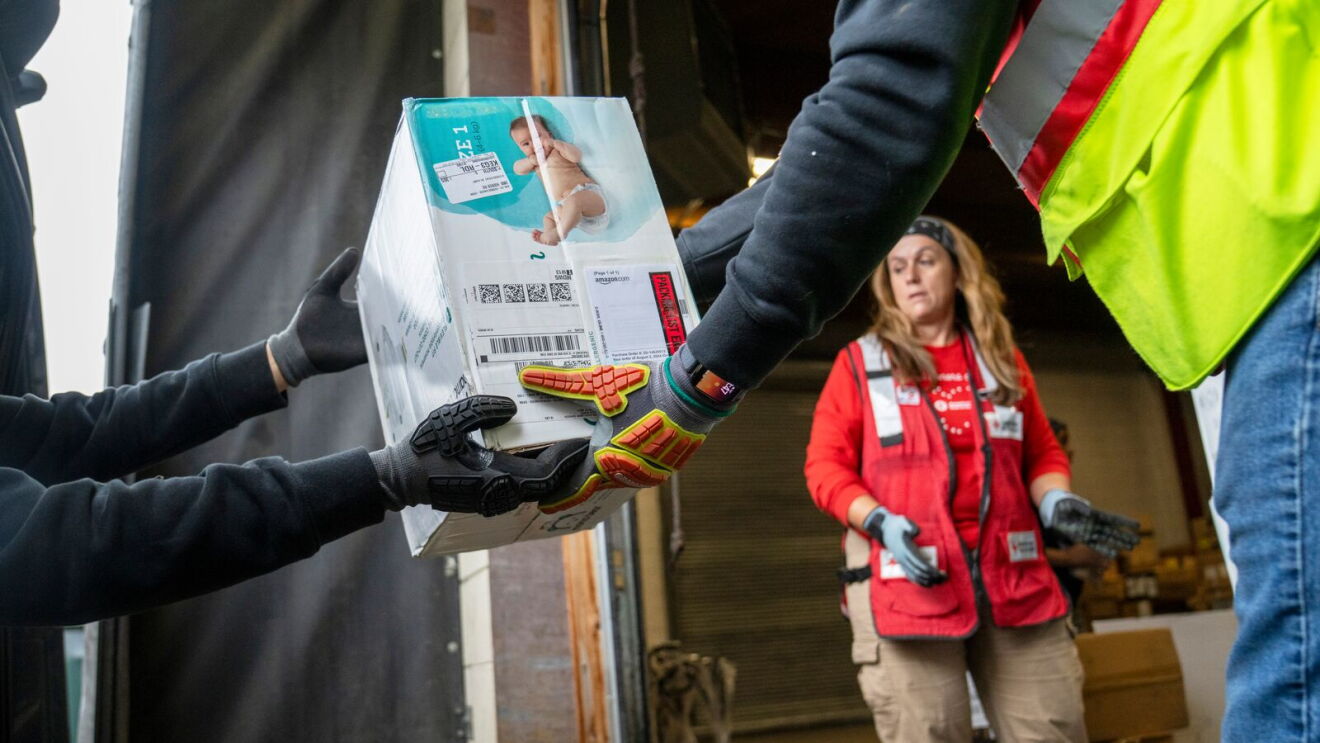 Red Cross volunteer supervising delivery of medical supplies