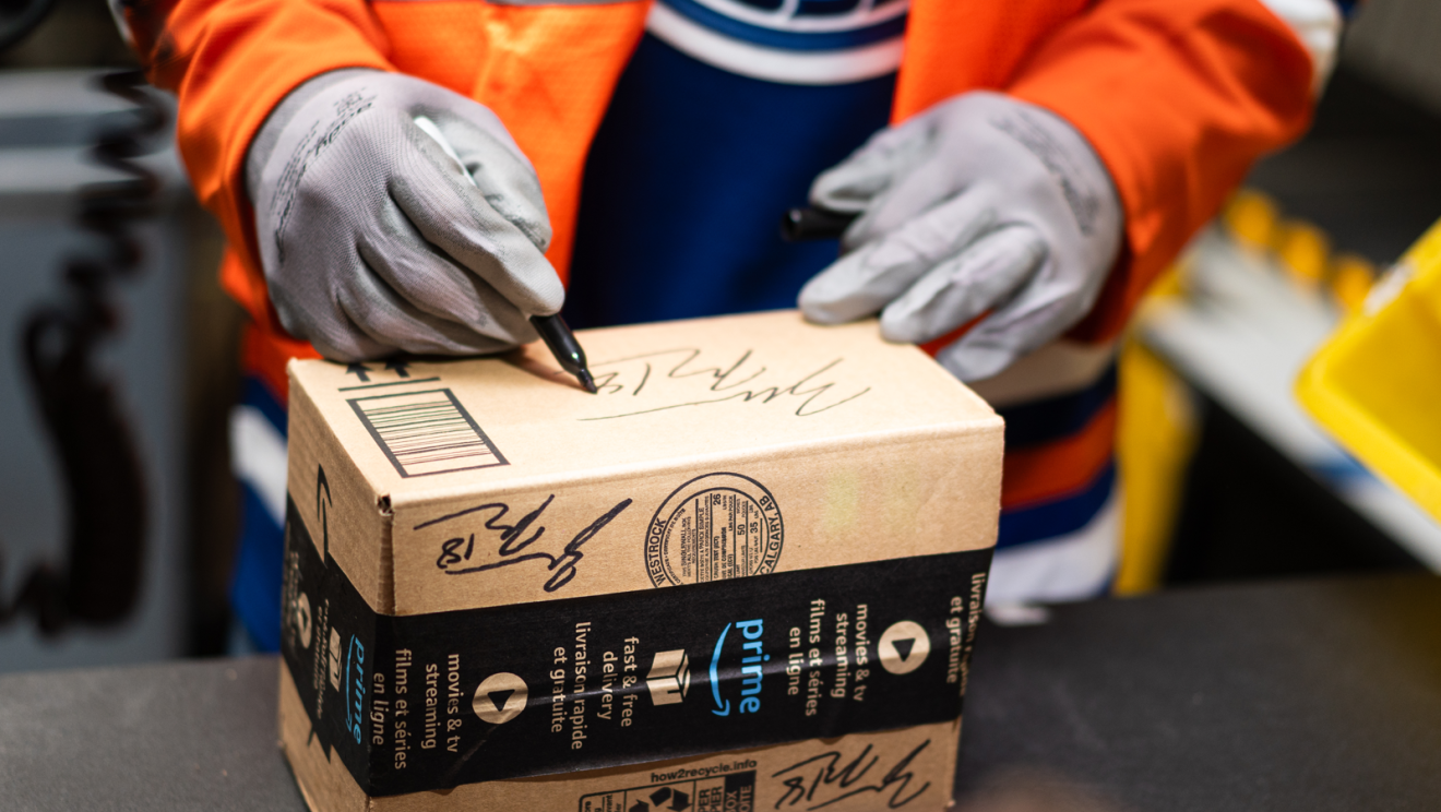hockey player helping package boxes 