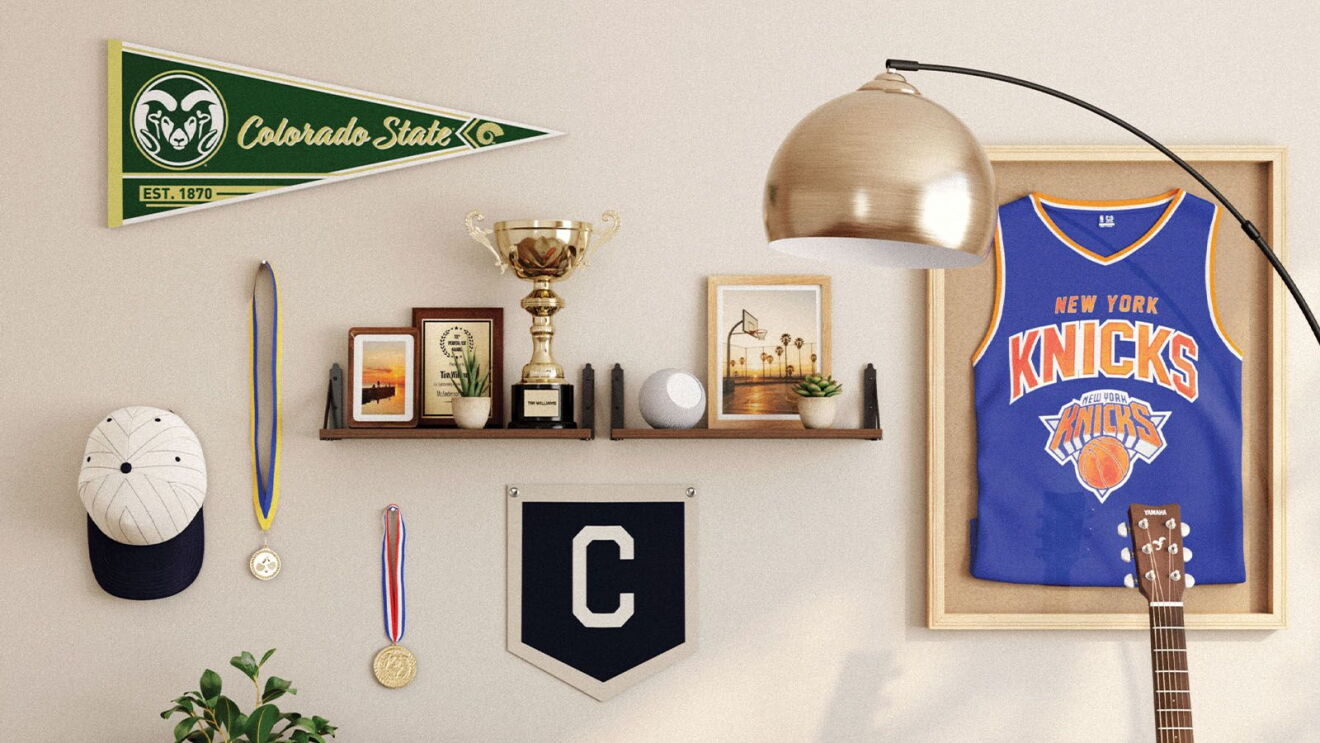 Wall display featuring Colorado State pennant, trophy, medals, New York Knicks jersey in shadow box, and decorative shelving with plants