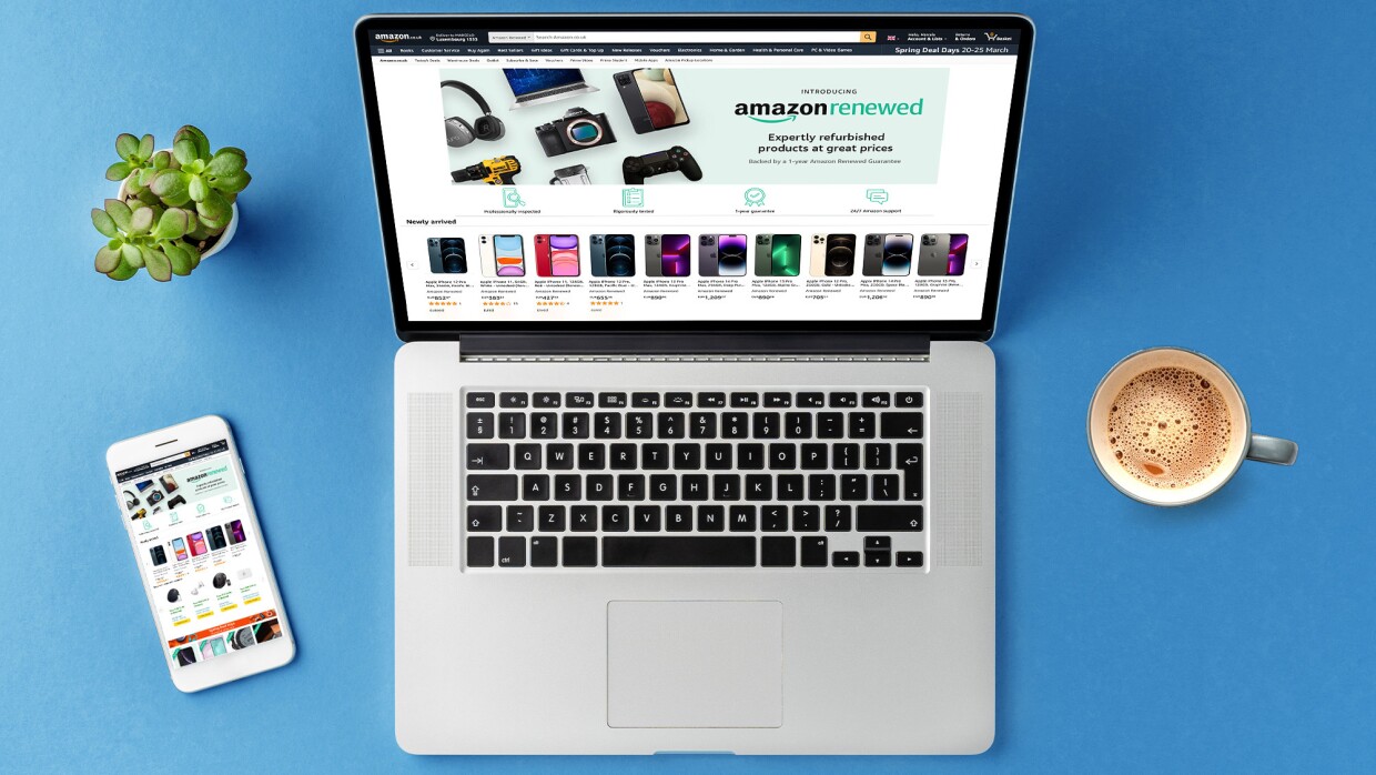 Laptop computer alongside mobile and coffee cup, displaying Amazon Renewed storefront