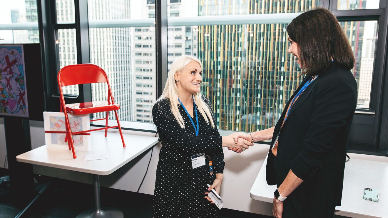 Human rights activist Kendall Alaimo presents a red seat to Amazon’s Worldwide Social Responsibility team during Amazon’s Tech Against Trafficking Summit in Seattle. The seat symbolizes social inclusion and the pathways to sustainable freedom for human trafficking survivors. 