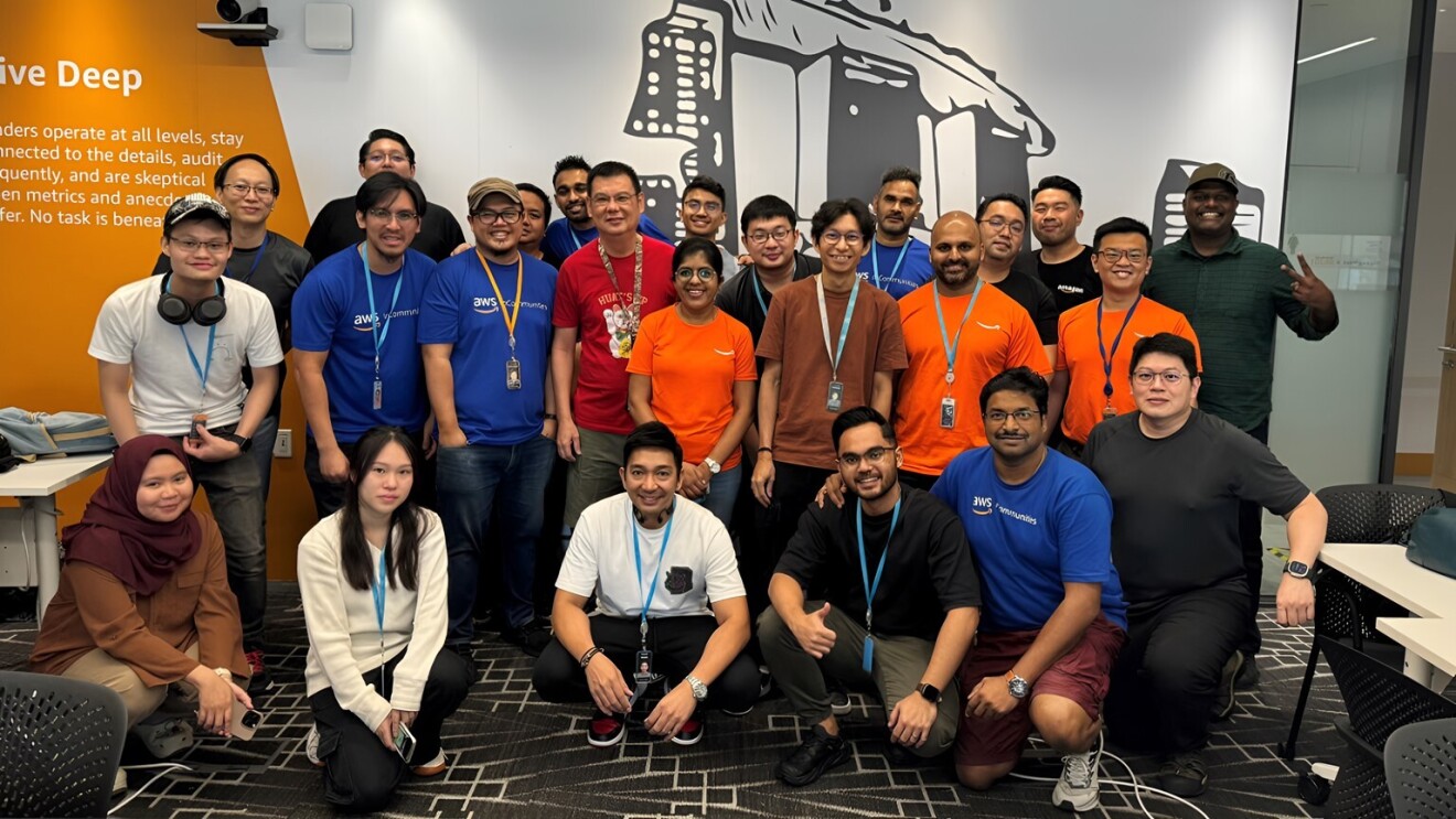 AWS employees in Singapore volunteering as part of a laptop refurbishment project benefitting people in need taking a group shot