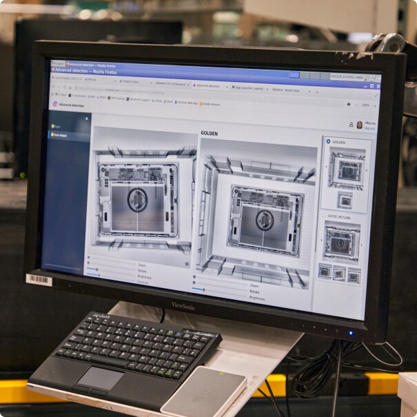 Screen showing two X-ray images of a laptop
