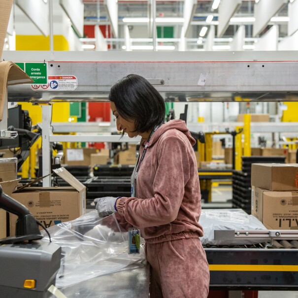 a young woman in a pink overall is packing in BGY1