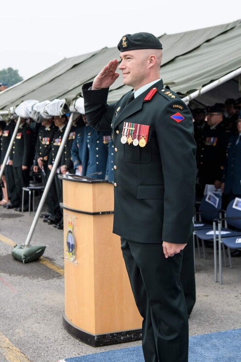 A man saluting in a Canadian military uniform