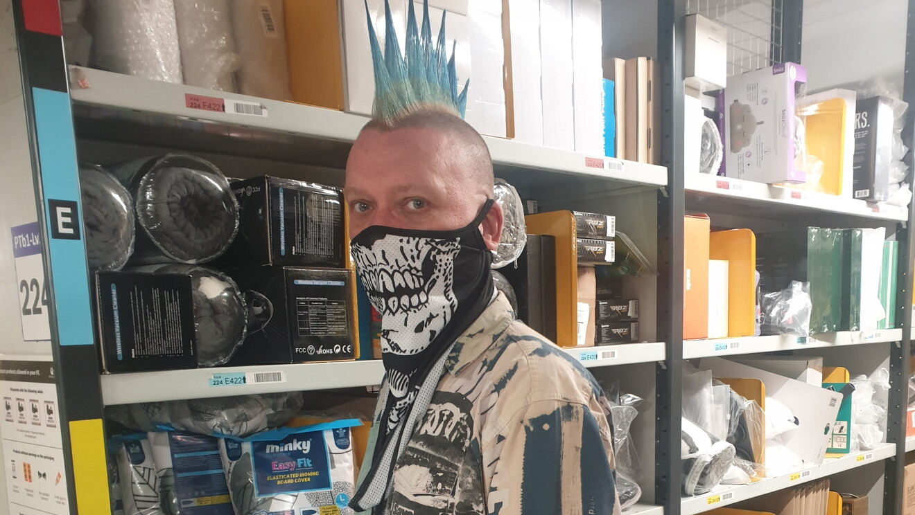 Martyn Janes wearing a facemask and standing in the fulfilment centre.