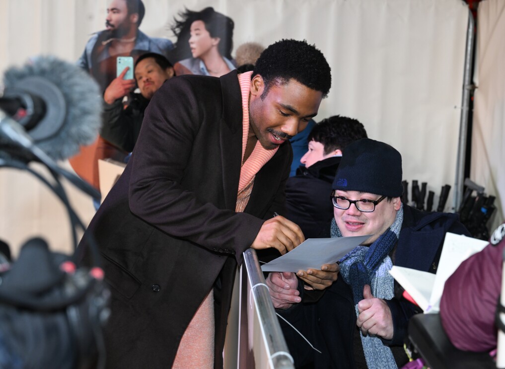 Donald Glover signing an autograph for a fan