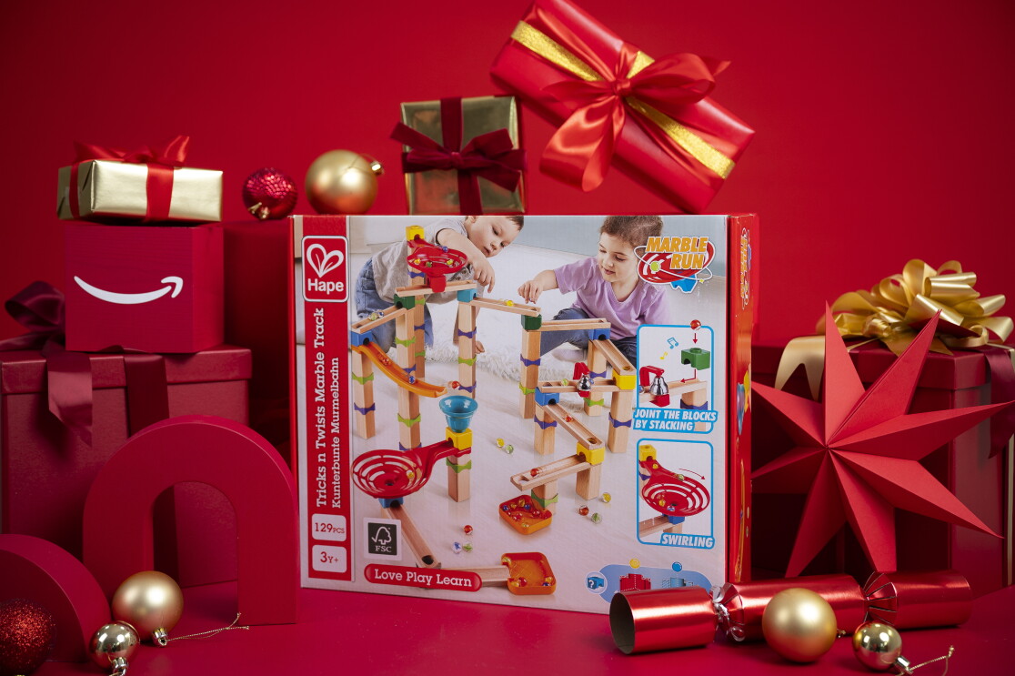 Hape Marble Run Construction Toy surrounded by christmas packaging 