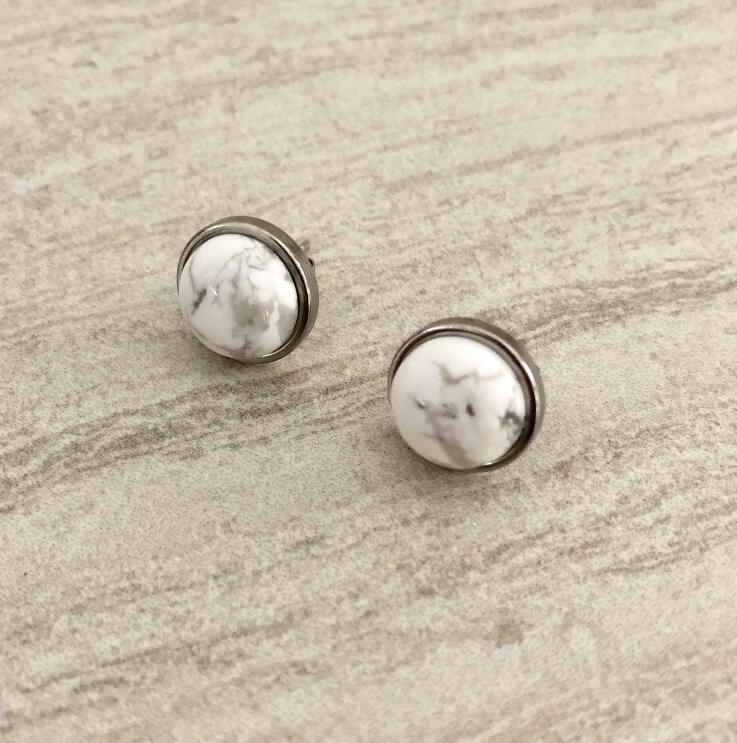 A flat shot of handmade jewelry with raw and semi-precious stones made by T. Victoria.