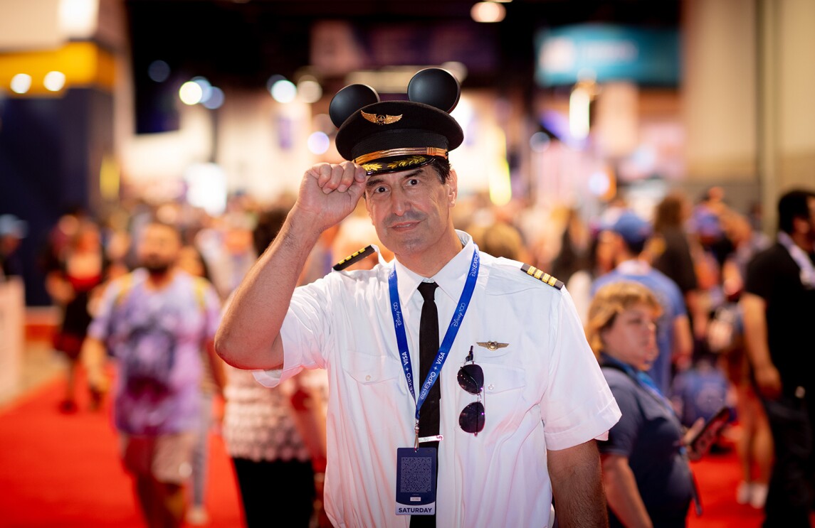a man dressed as the mickey mouse pilot at the D23 convention
