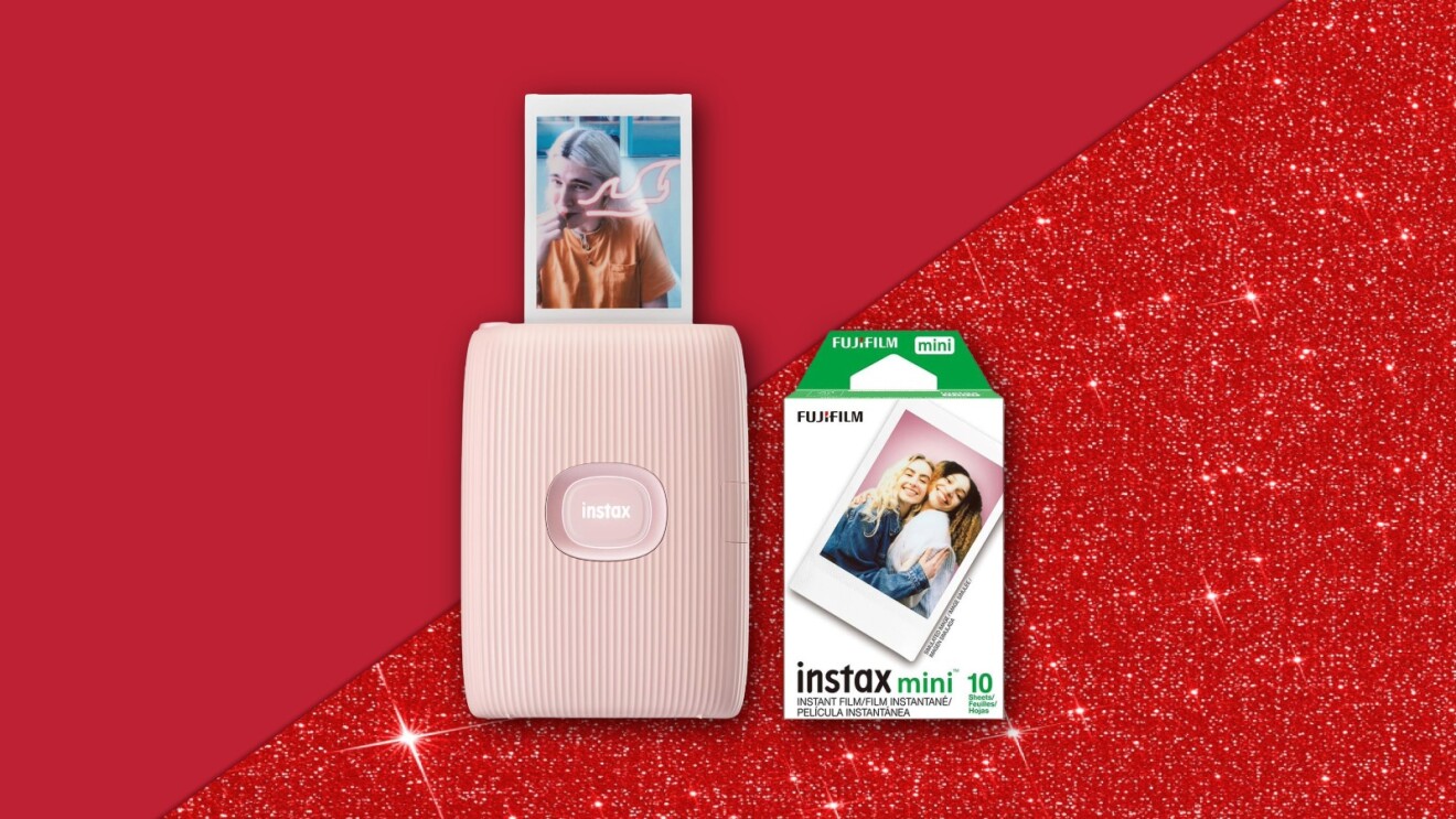 Fujifilm Instax Mini printer with photo and film pack on red background