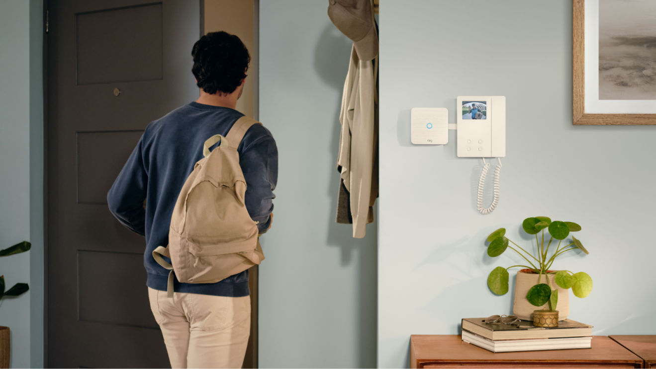 Home interior showing person departing, Ring Video Intercom on wall