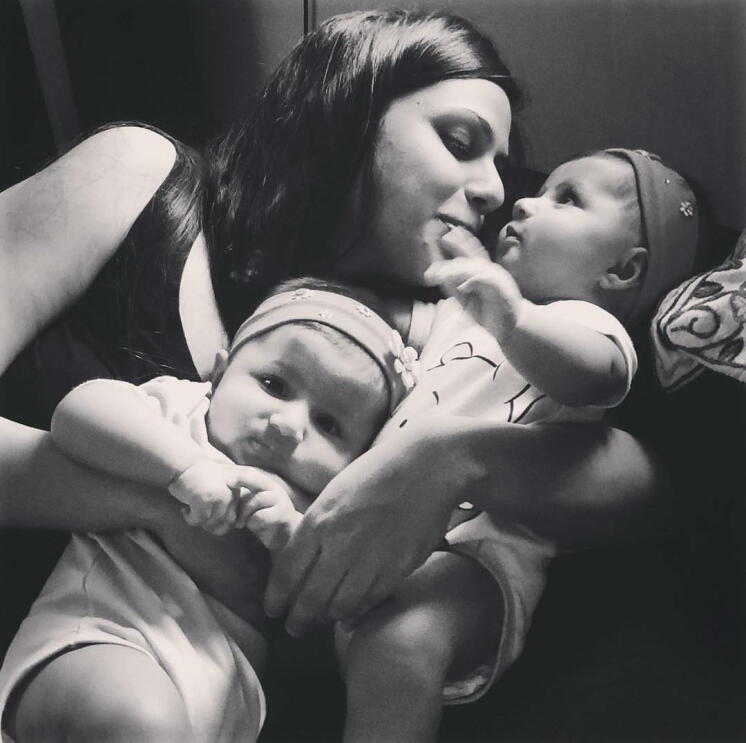 In the picture, Maliha is cuddling her two babies