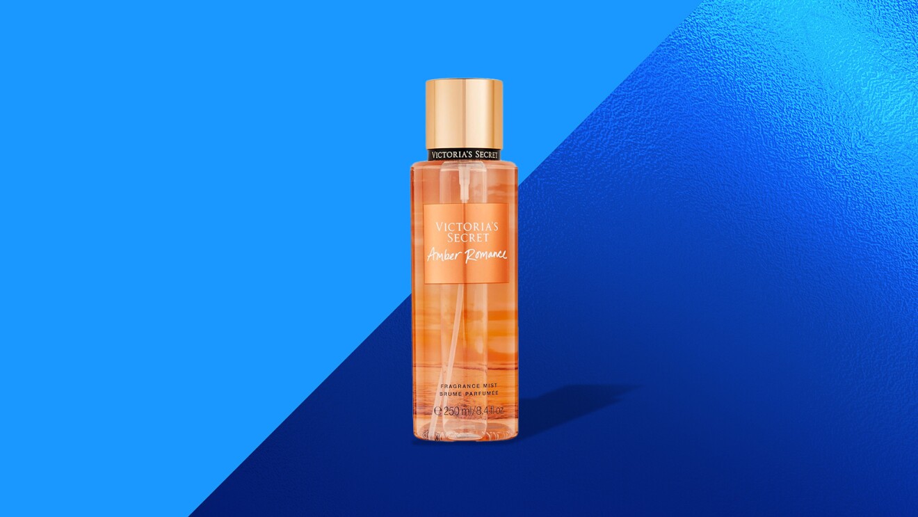 Victoria's Secret Amber Romance fragrance bottle against blue backdrop