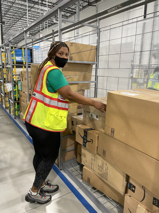A single person in a safety vest at work with Amazon