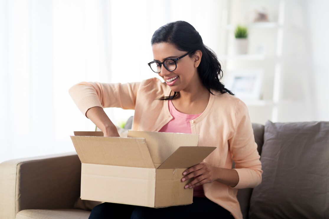 A woman opening an Amazon parcel