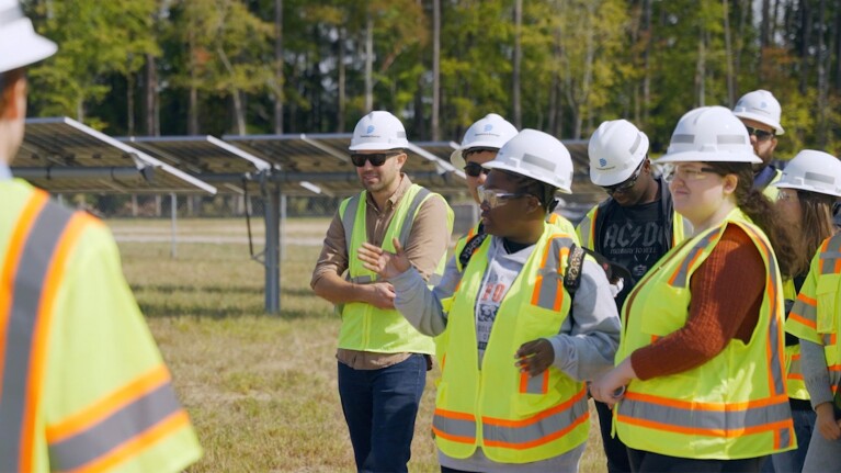 An image of a student group visiting a solar farm. 