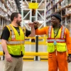 two amazon employees fist bumping 
