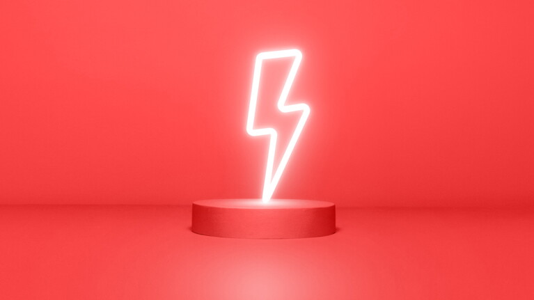 Neon lightning bolt on red circular platform against red background