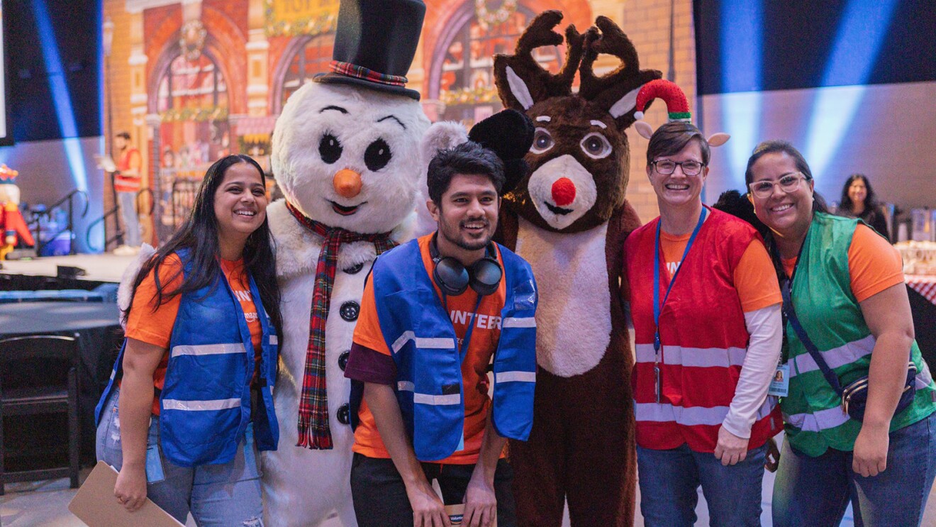 A photo of characters and Amazon volunteers inside Amazon's Winter Wonderland.
