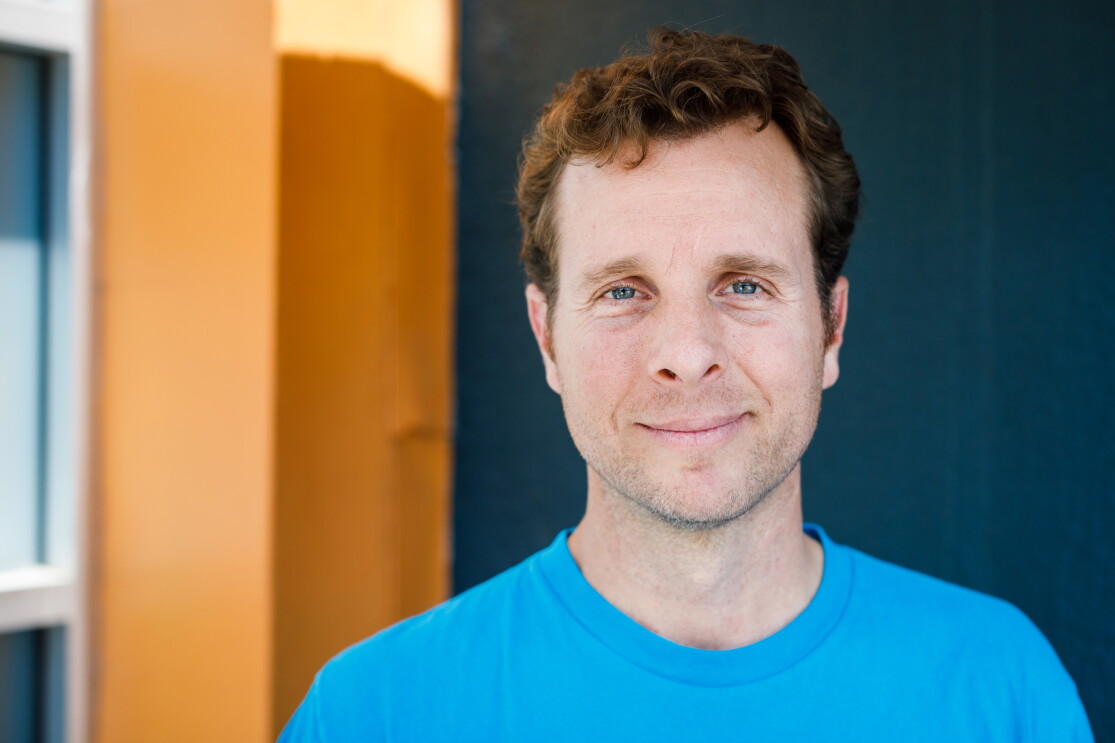 Jamie Siminoff, founder of Ring, in a blue t-shirt looks at the camera.