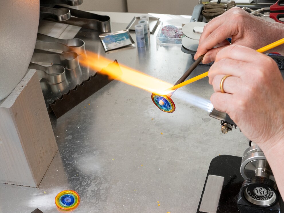 Glasschmuck wir in Feuer gehoben und verfeinert.