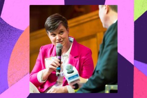 An image of Amazon Community Engagement Manager Keri Pravitz speaking with a microphone in an interview. 