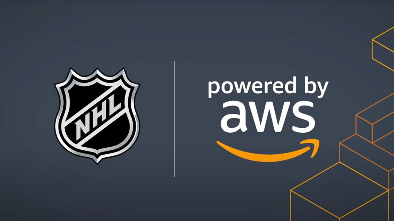 An image with a dark blue background that displays the National Hockey League logo next to a text that says "powered by AWS" with Amazon's smile logo below it. There are orange outlines of boxes on the right side of the image. 