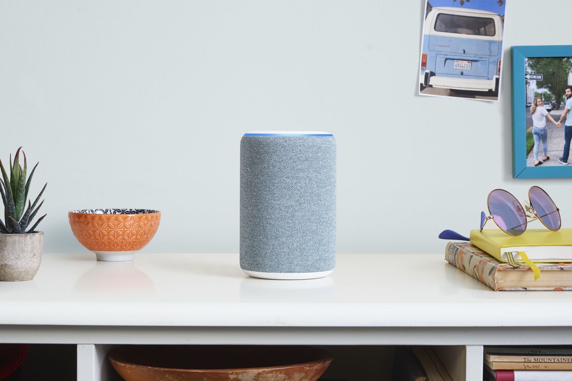 Alexa device sat on top of white desk 