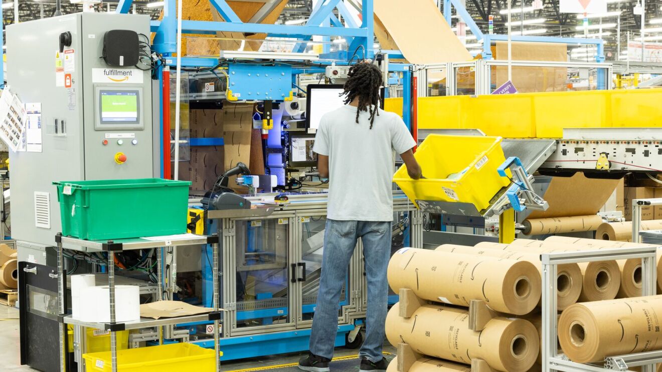 Individual worker working with smart paper in warehouse.