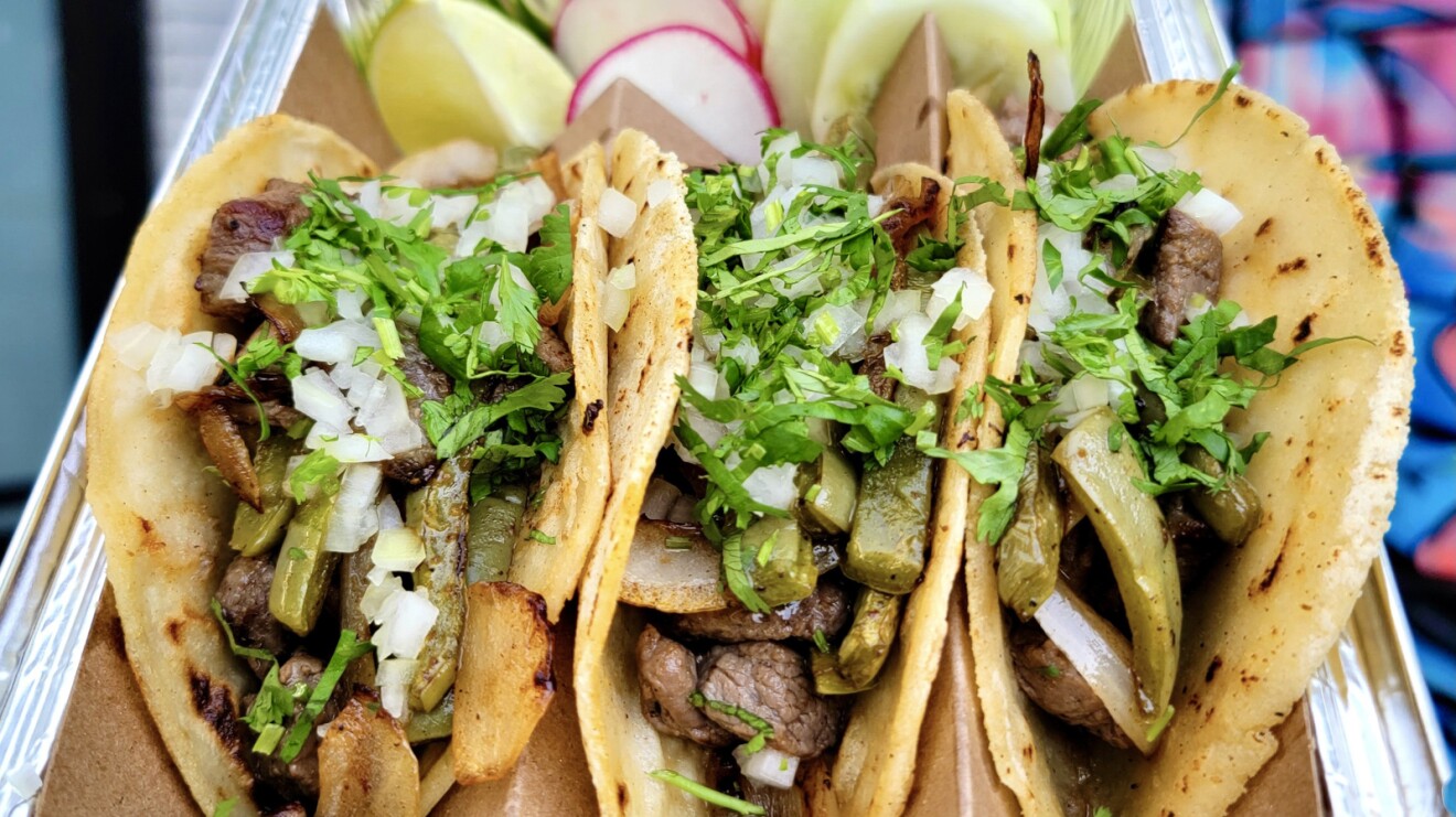 A photo of three tacos.