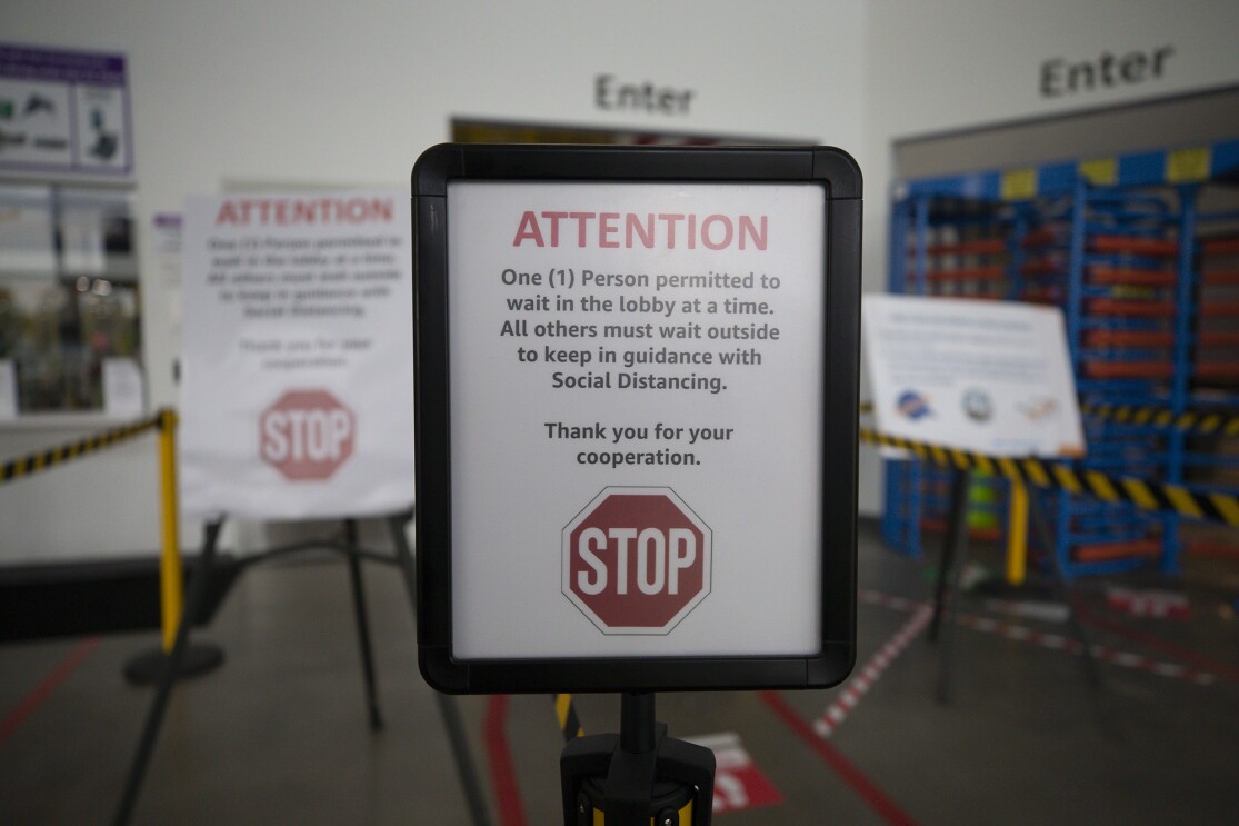 A sign at an Amazon fulfillment center noting social distance requirement