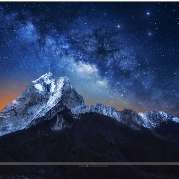Fire TV Omni Series smart TV that is displaying a mountain range at nicht.