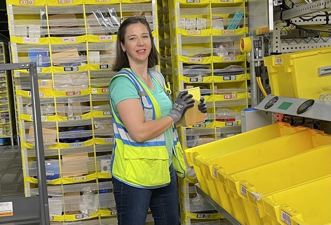 Catherine Lemonds smiles as she works in a fulfillment center.