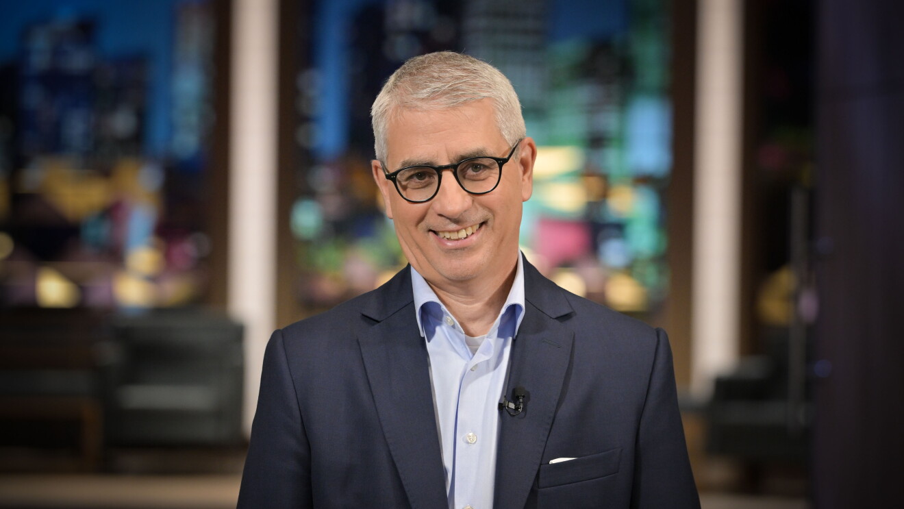 Man with glasses in front of window 