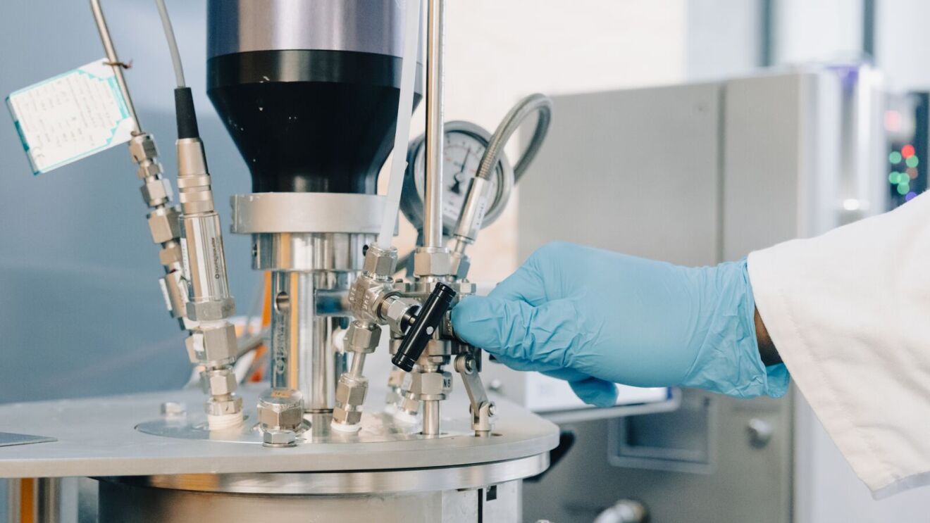 Lab technician adjusting equipment by PAEBBL