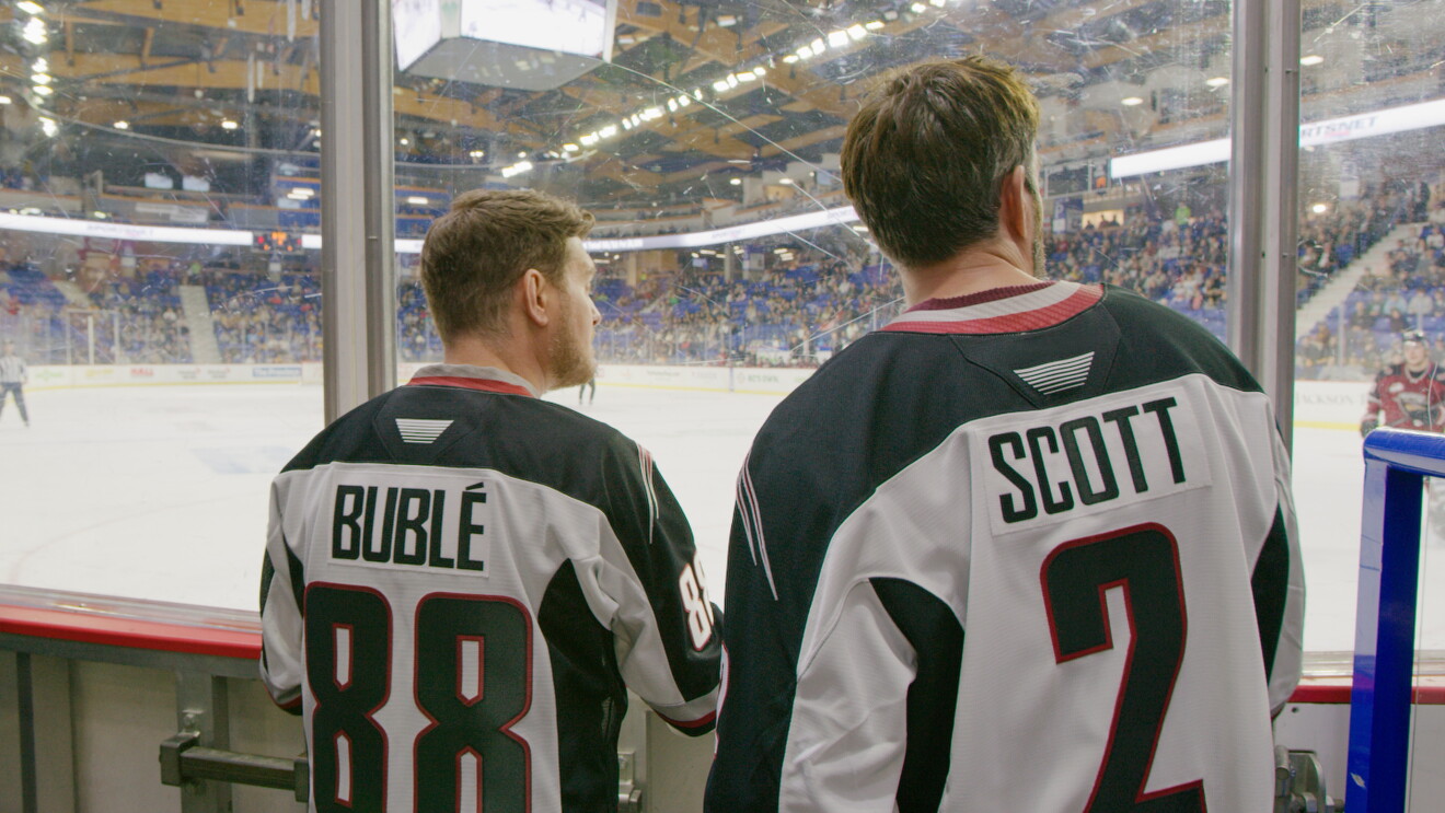 two men look at hockey rink