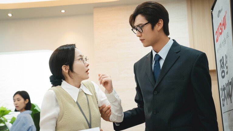 man holding sleeve of surprised woman; ‘Marry My Husband’