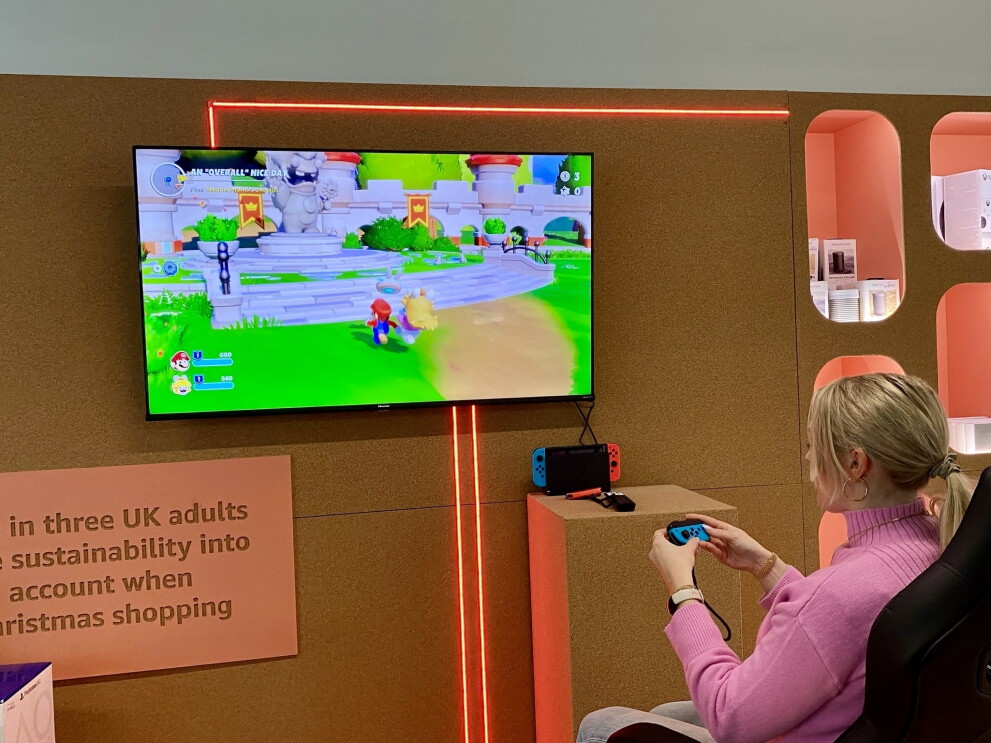 A young woman play with a nintendo switch at the Second Chance store 