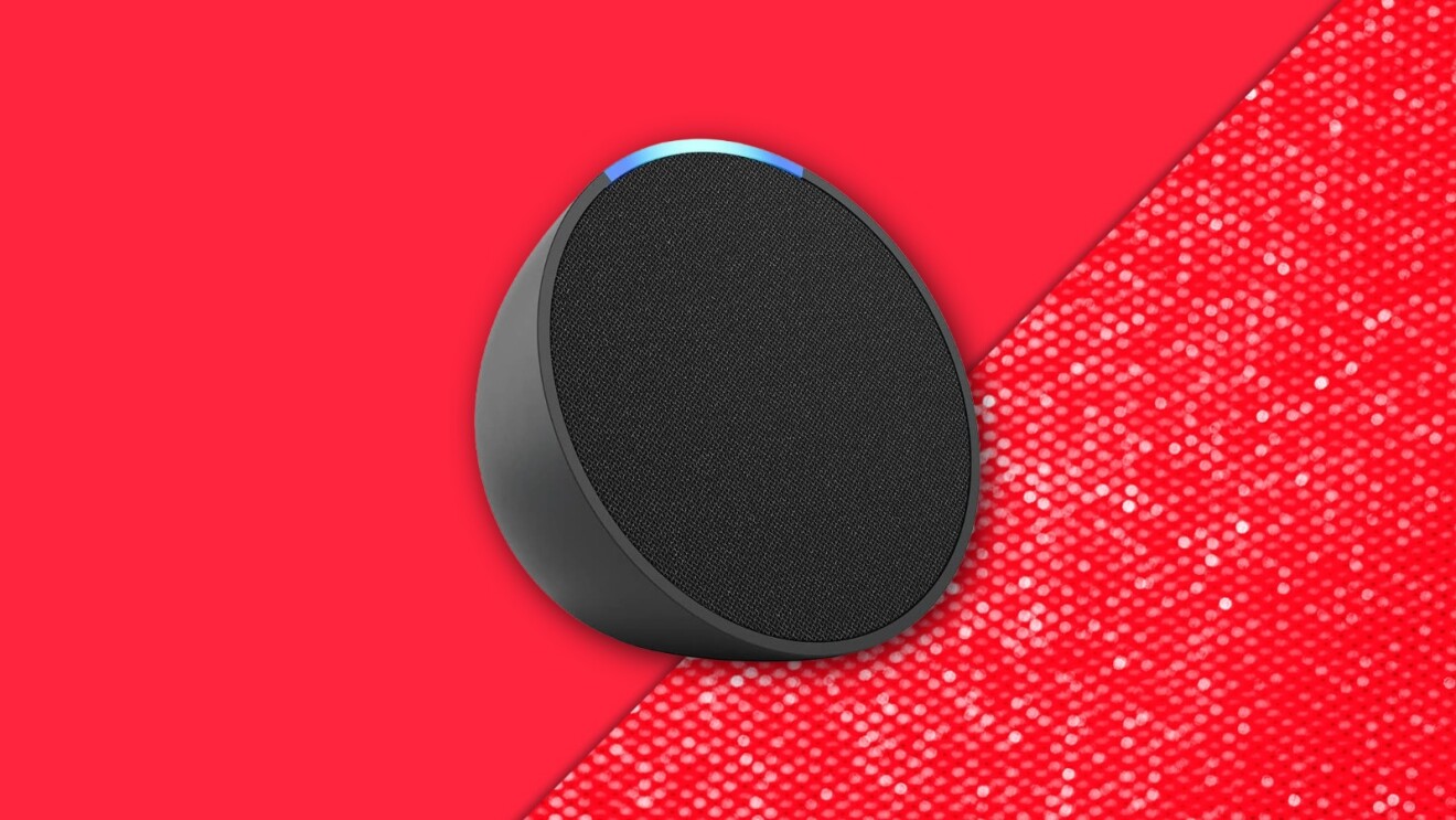 Circular black Echo Pop speaker on vibrant red background with textured corner