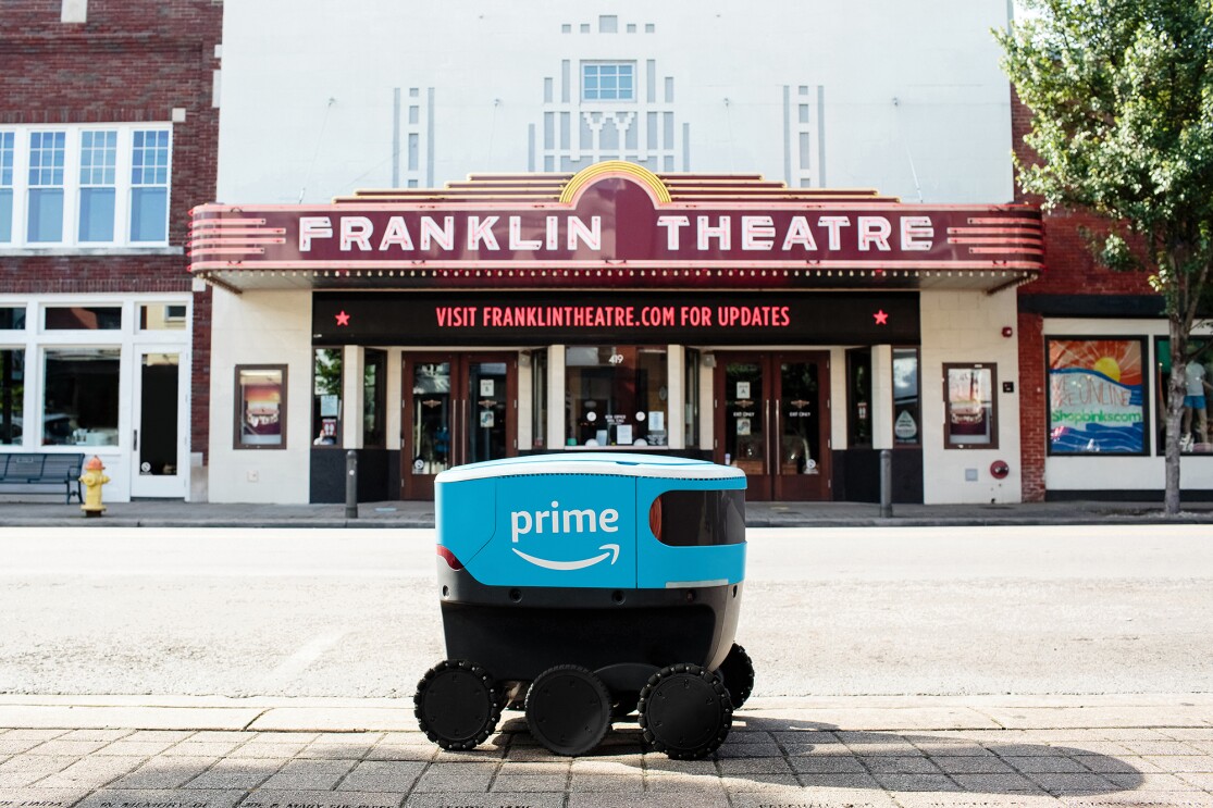 Amazon Scout bot posed in front of iconic landmarks