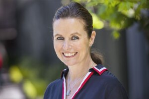 A headshot of Claire Peters standing outside.