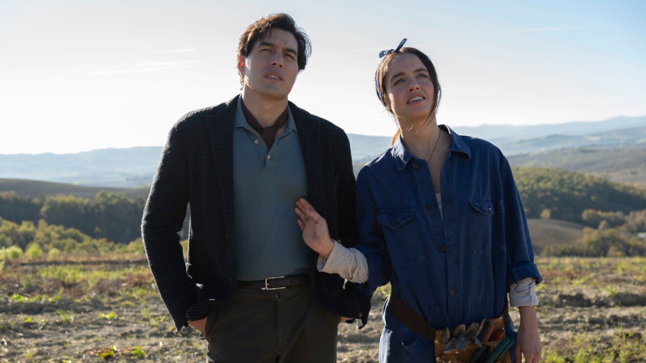 A man and woman looking into the distance in a mountain setting