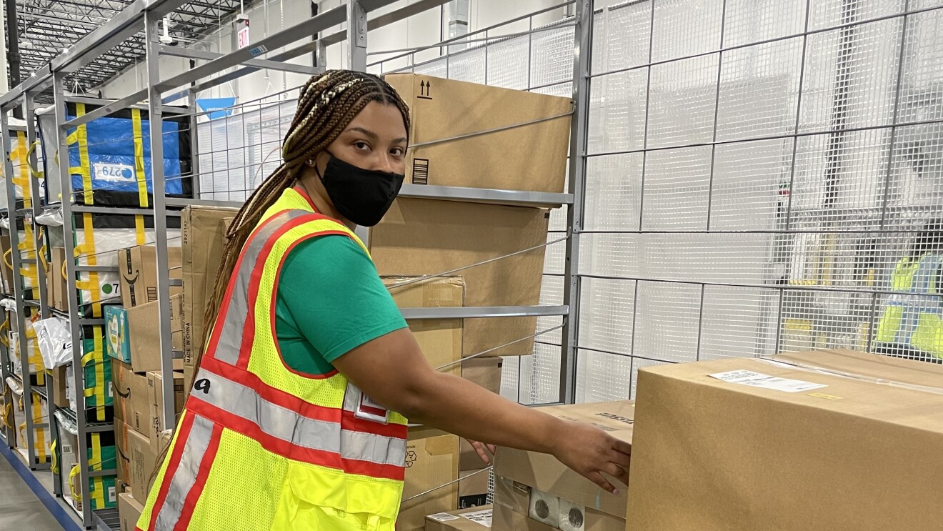 A single person in a safety vest at work with Amazon