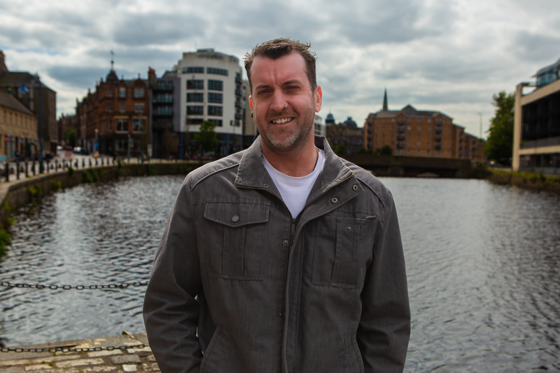 Hamish Allison standing in front of a canal 