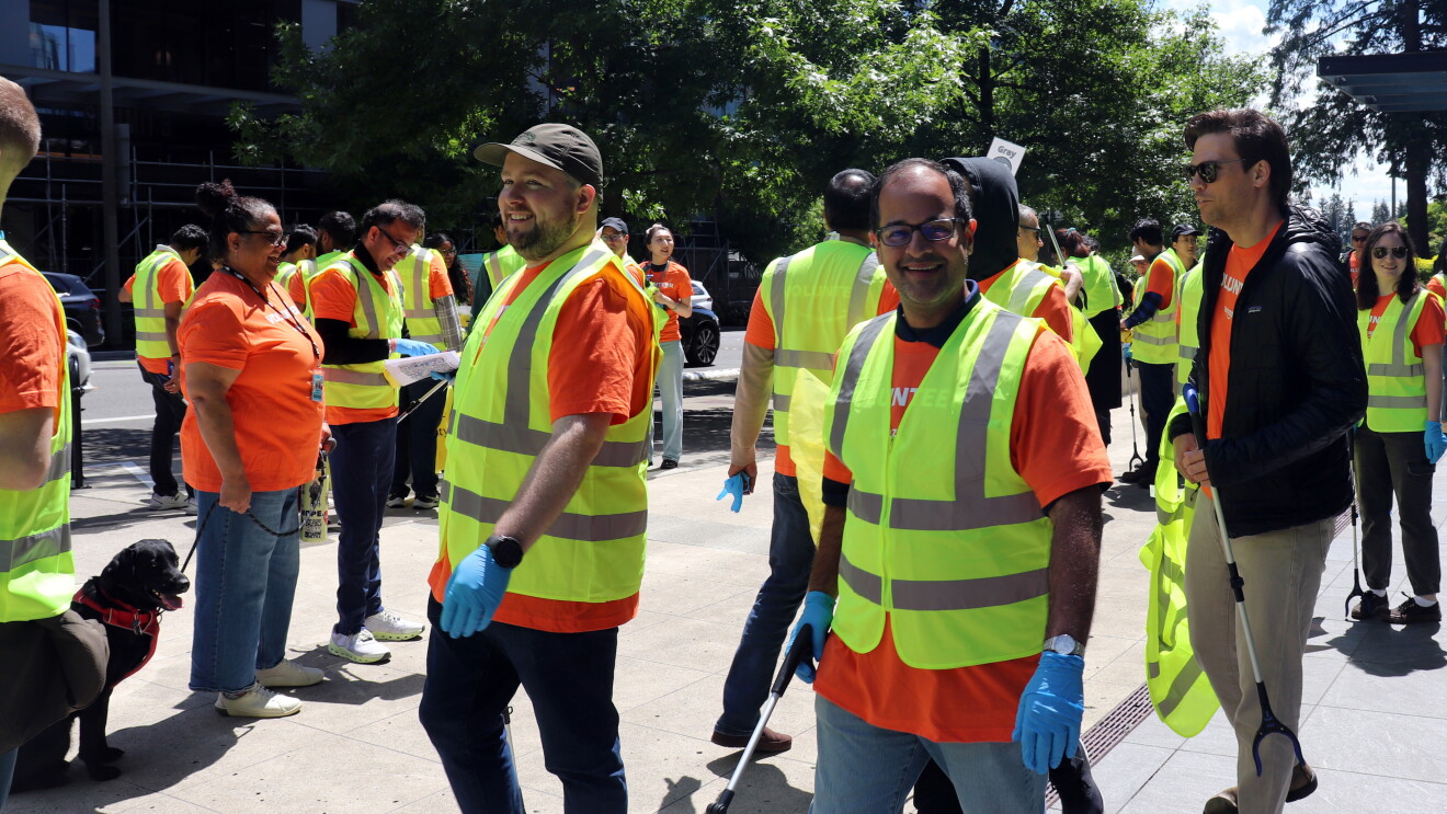 Volunteers in high-visibility vests gather for community clean-up event
