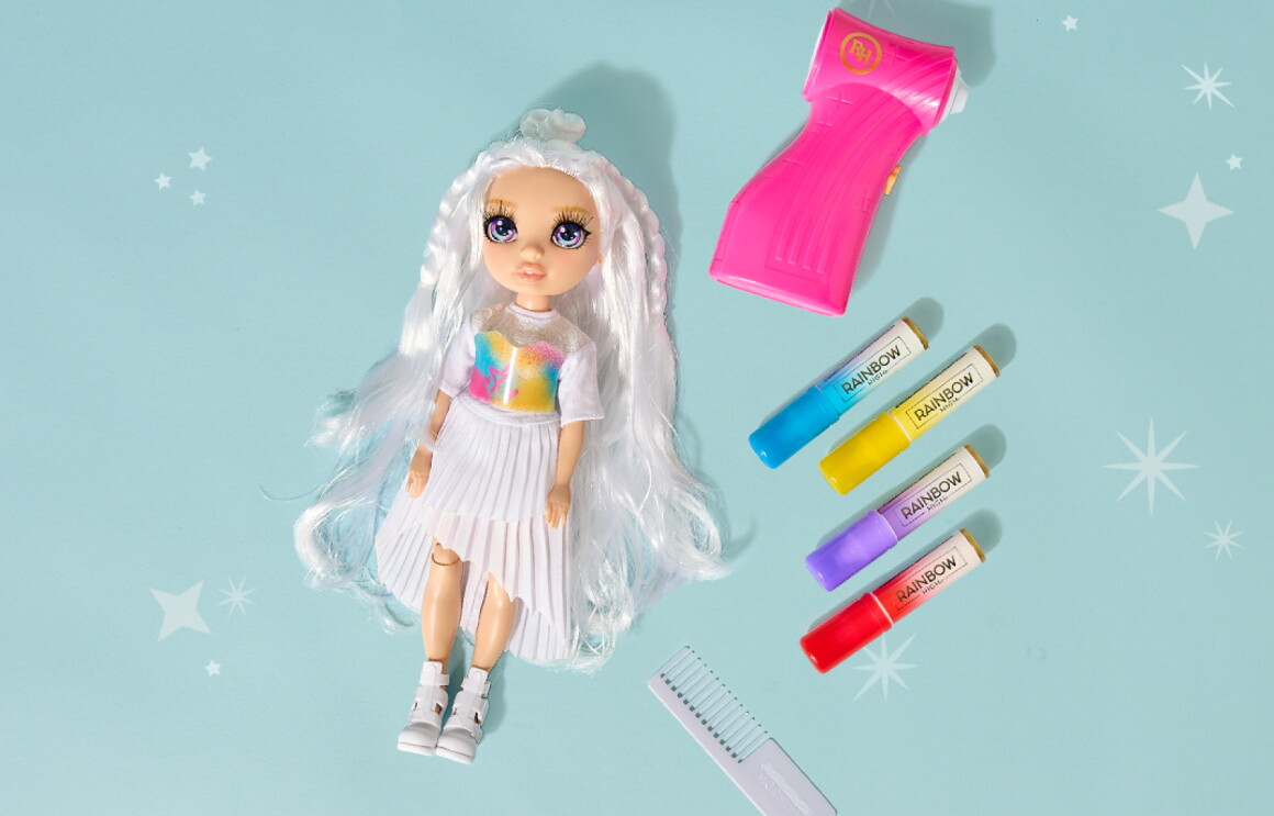 Doll with long white hair next to colorful markers and a comb