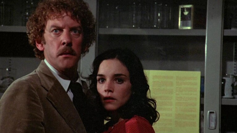 Tense scene with older man and younger woman in laboratory-like environment