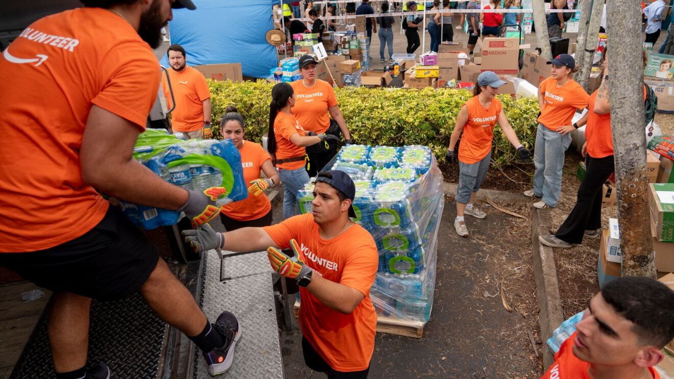 Volunteers from Amazon sort and pack emergency supplies for Venezuela earthquake relief alongside the nonprofit Global Empowerment Mission in Miami, Florida on June 30, 2026.